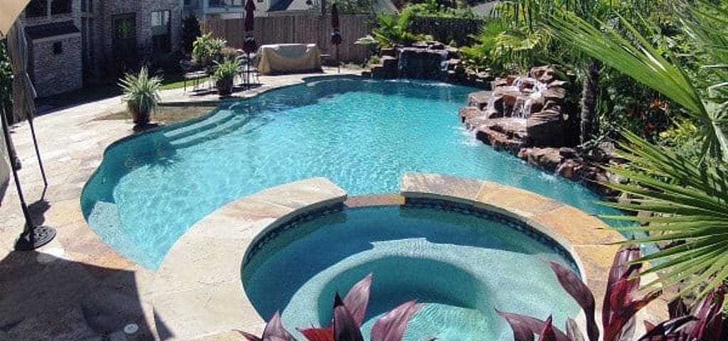 pool, spa, rock waterfall, plants, the Backyard Pool Specialists