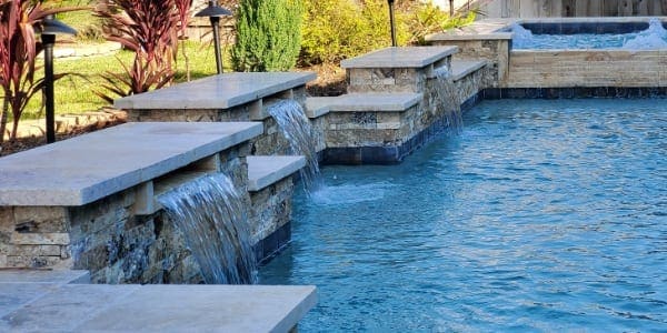 water features on the ledge of a pool
