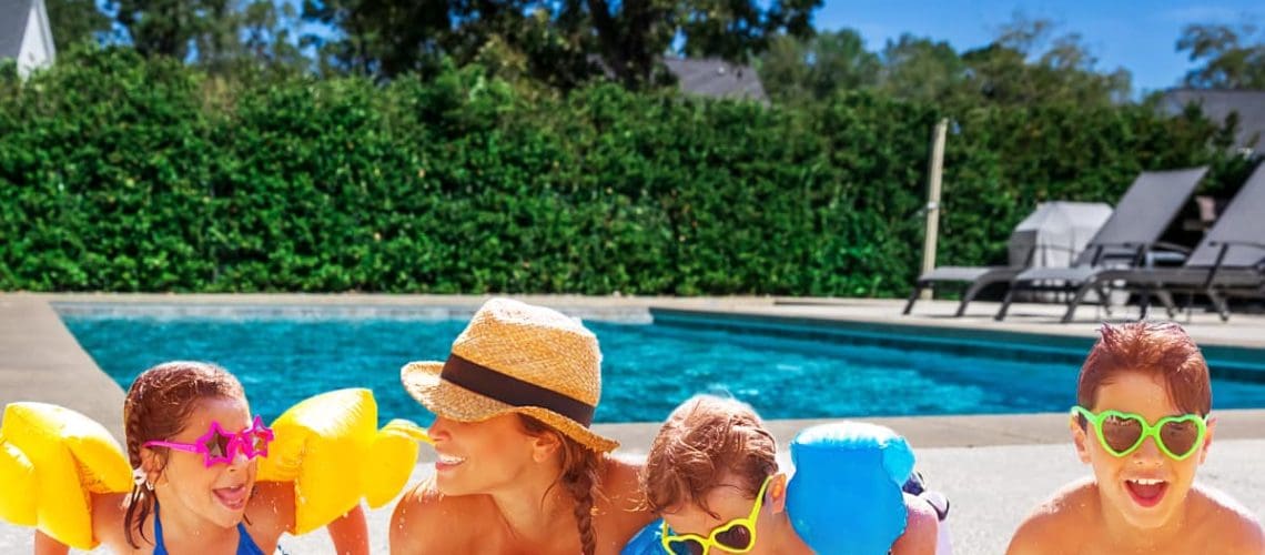 family with pool in background, concept of Affordable Pool Special Packages for Montgomery, TX Homes