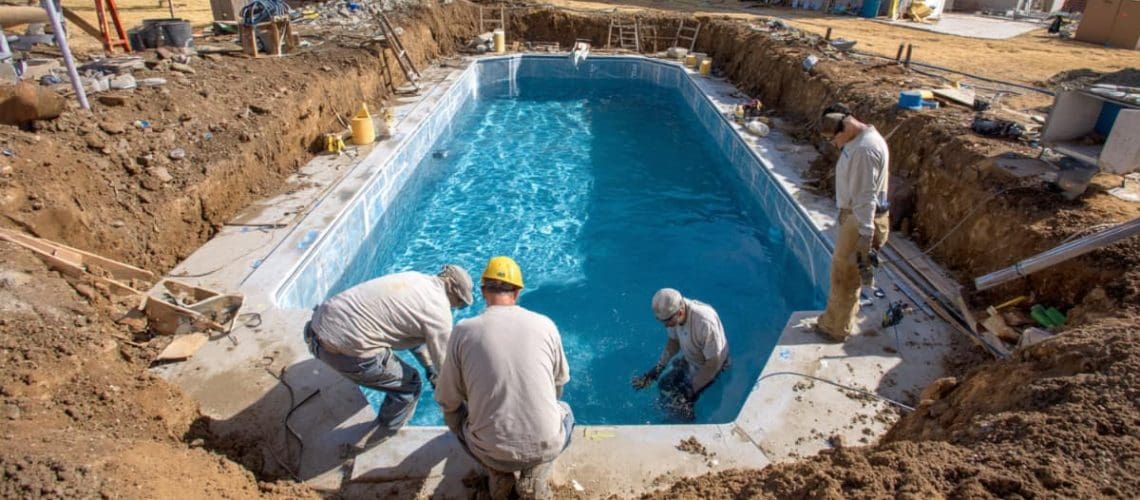 pool contractors building an inground pool, concept of plan your pool build in winter and swim by spring