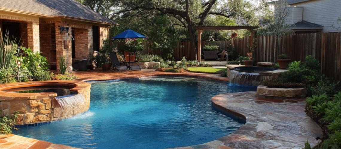 pool with stone spillover spa and stone deck, concept of clean pool with Saltwater Pool Maintenance for Texas Homes